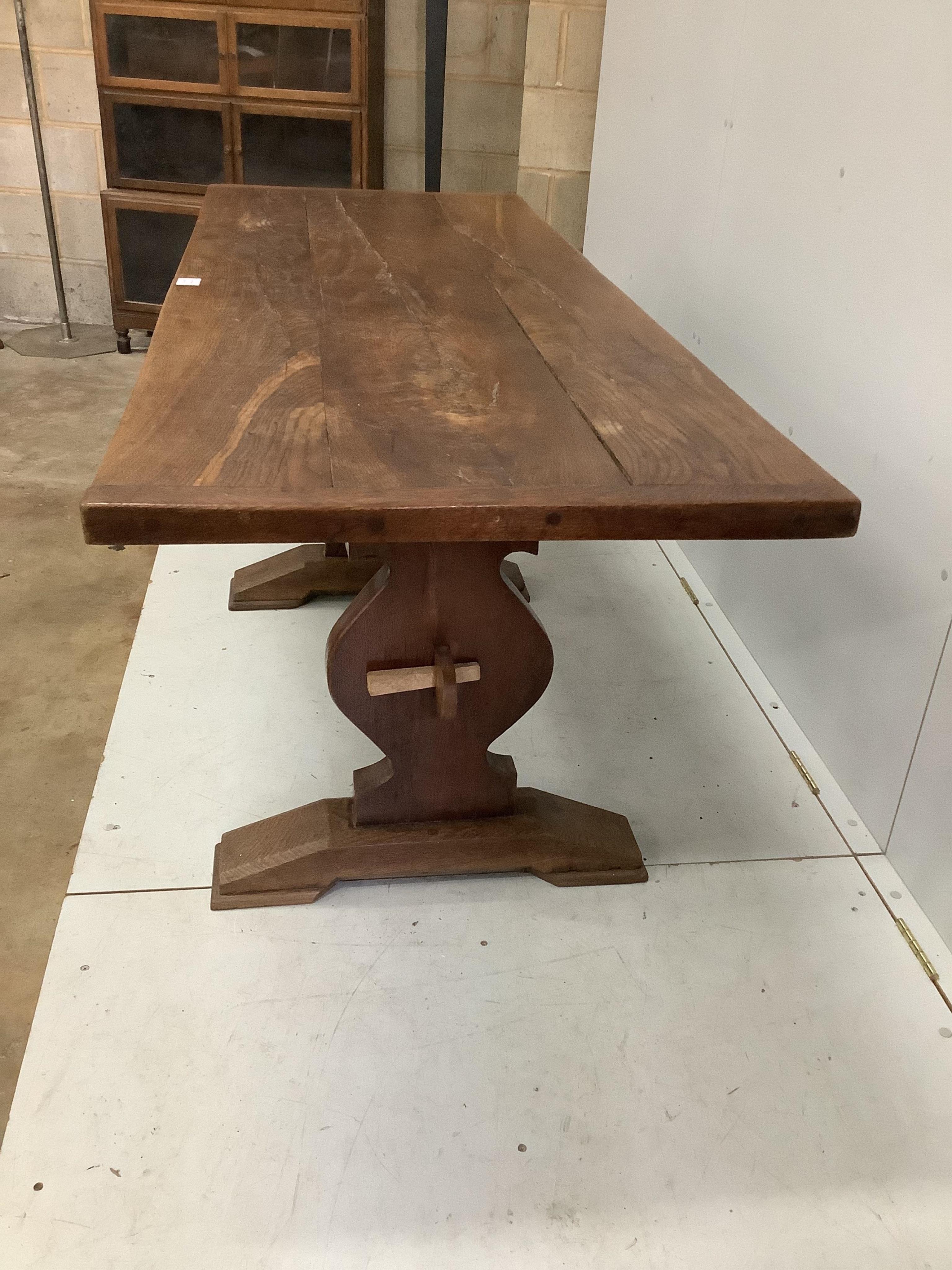 An 18th century style rectangular oak refectory dining table, on shaped end standards, width 176cm, depth 68cm, height 74cm. Condition - fair